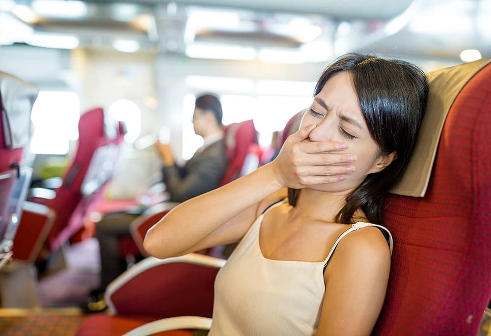 Image of a Woman feeling sick during travel